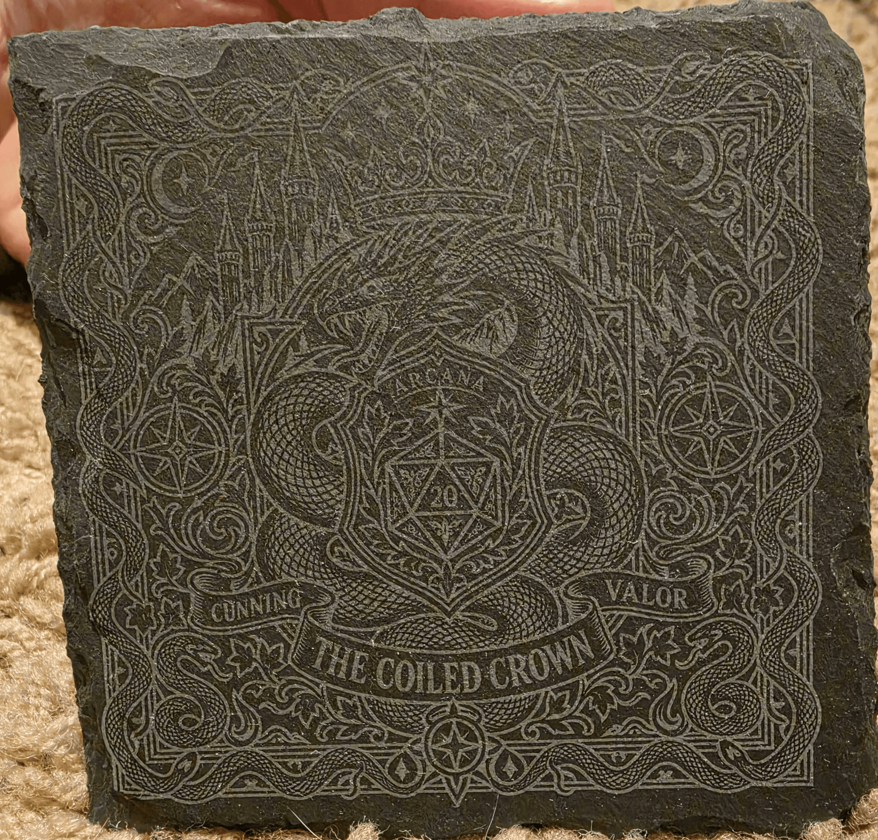 Square slate coaster engraved with an intricate dragon, castle, and ornamental border